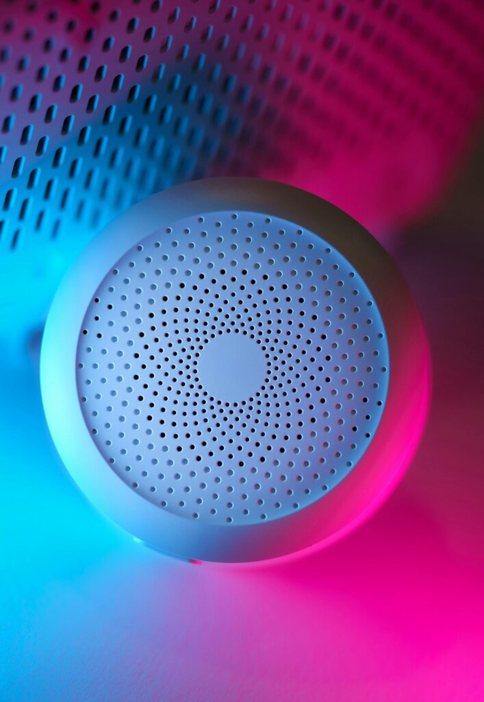Modern smart home device with vibrant neon blue and pink lighting, showcasing advanced design.