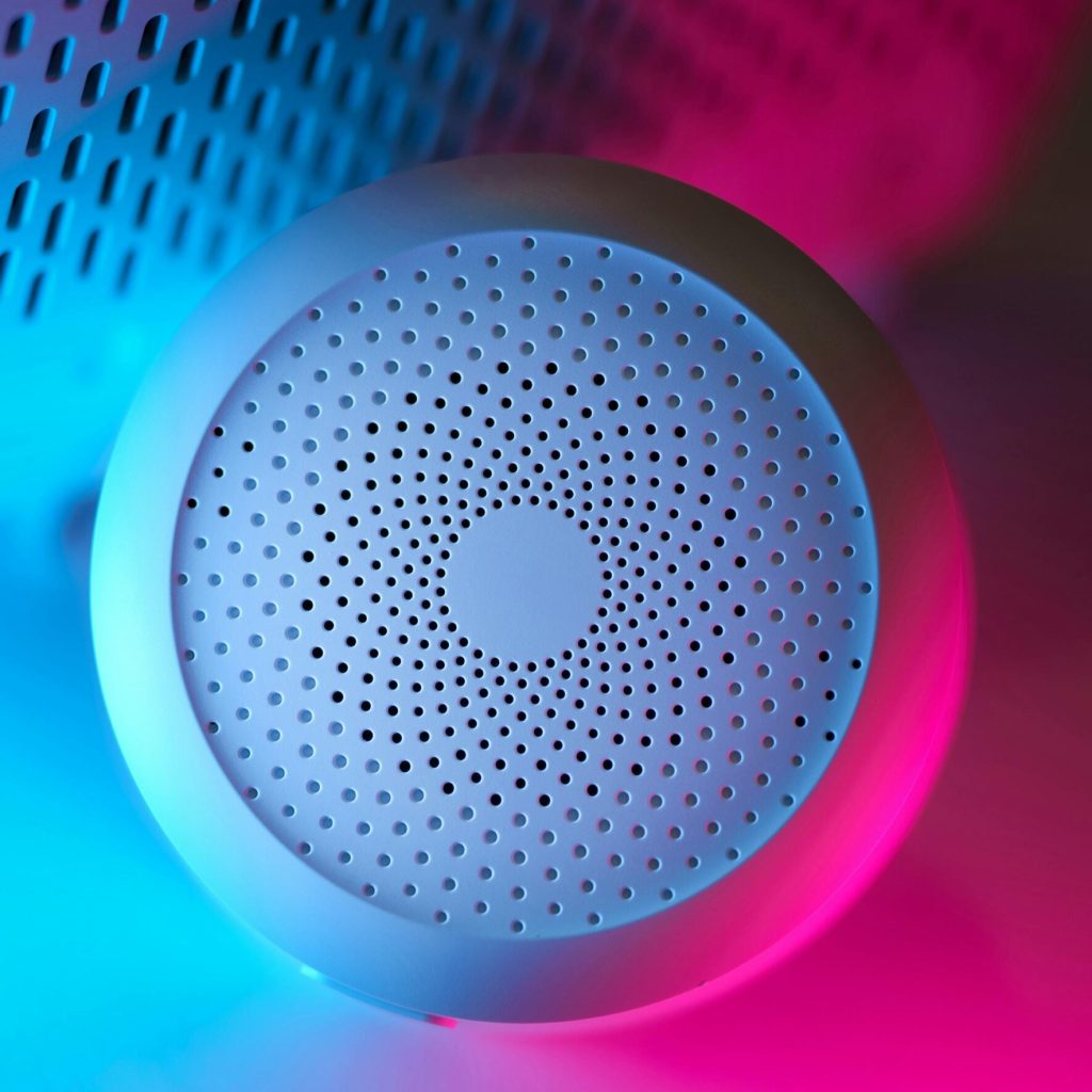 pexels-photo-28374473-28374473 Modern smart home device with vibrant neon blue and pink lighting, showcasing advanced design.